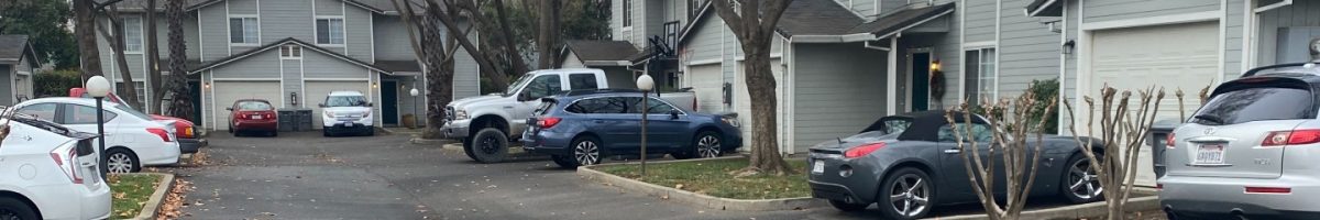 street view of gray houses with cars parked in driveway