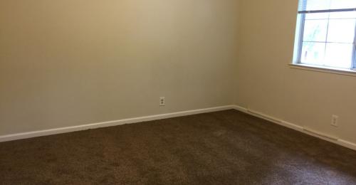 Bedroom with dark brown carpet